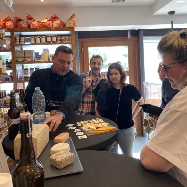 Un commerçant passionné présente ses fromages à une équipe lors d'un rallye gourmand à Saint-Quentin